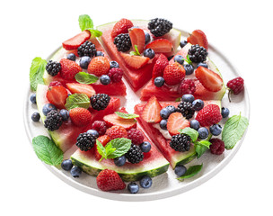 Watermelon pizza in slices with berries and mint isolated on white