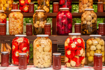 Fototapeta na wymiar many jars with colored pickles