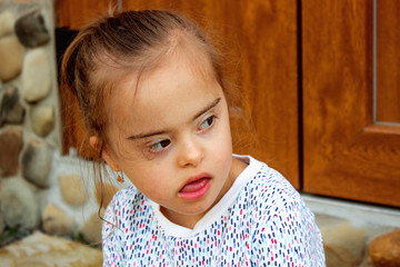 Girl with Down Syndrome. Recreation and medicine concept