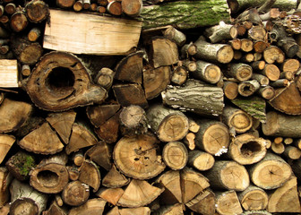 Different size firewood stored in pile. Abstract background
