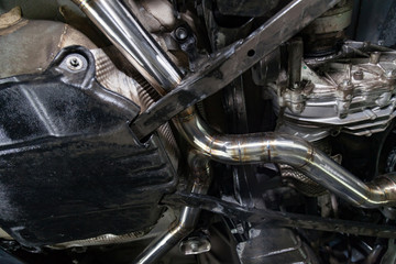 Fabrication and installation of a stainless steel car exhaust pipe with a bifurcation and a louder sound with a color weld under bottom. Tuning and auto service industry.