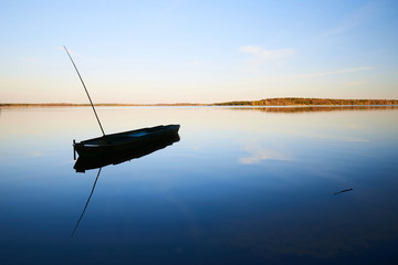 solitary fisherman boat on the fish pond Rožmberk, Czech republic's largest pond, Europe, during...