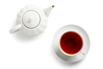 Tea in a white cup and teapot. Isolated white background.