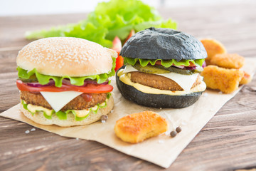 Delicious fast food. Delicious hamburgers on wooden background