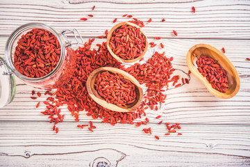 Wooden bowl with goji berries on the table closeup.top wiew
