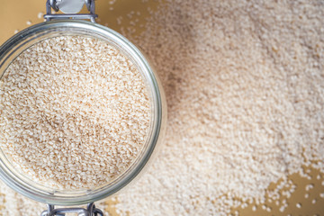 Sesame seeds isolated in bowl, top view