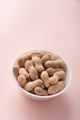 Tasty peanuts in a white bowl