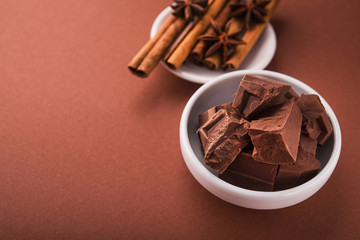 Pieces of chocolate and spices cinnamon, badian