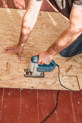 Floor leveling works - lay plywood on the floor boards