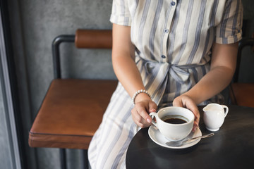 Young girl in a cafe with a coffee cup