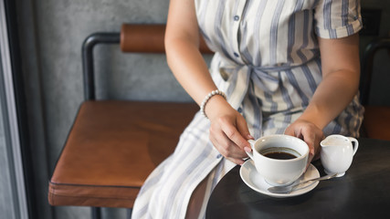 Young girl in a cafe with a coffee cup