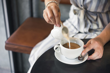 Young girl in a cafe with a coffee cup