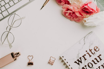 Office desk with computer and rose flowers