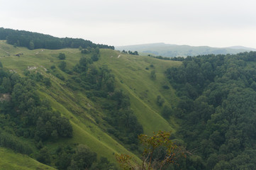 Fototapeta na wymiar Green lawn grass hill landscape in the caucasus mountains near kislowodsk