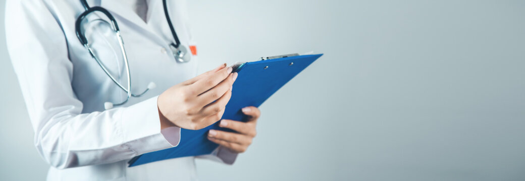 woman doctor hand documant on gray background
