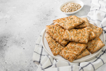Cookies with seeds in a white plate on a light table