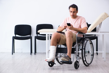 Fototapeta na wymiar Young injured man waiting for his turn in hospital hall