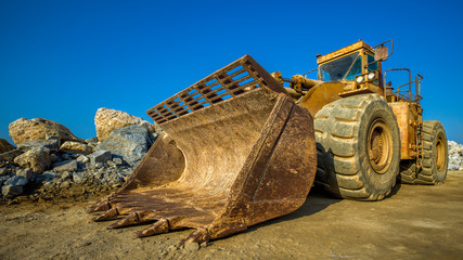 ein verrosteter Bulldozer vor Felsen und blauem Himmel © jsr548