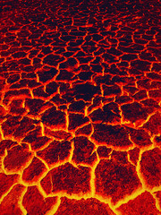 Heat red cracked ground texture burning after eruption volcano. Molten active lava texture...