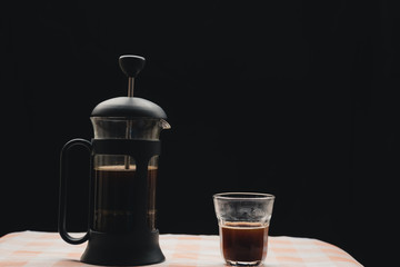 French press coffee maker, On the kitchen tablecloth and black background, Natural light, Selcetive focus, Vintage style.