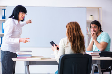 Old teacher and students in the classroom