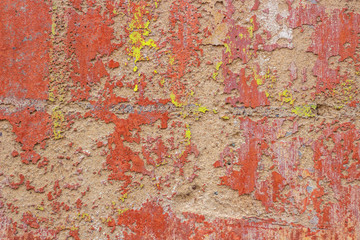 Old cracked weathered shabby red yellow painted plastered peeled wall banner background.