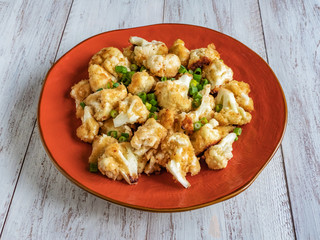 Cauliflower fried on a plate. Top view.