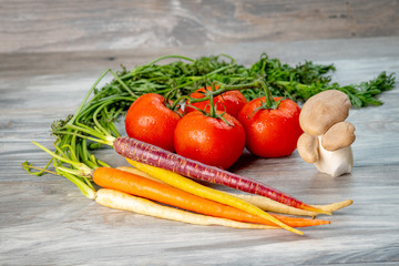 Carrots, mushrooms, and tomatoes close up so you can see their freshness