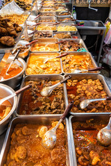 Variety of Burmese curries in cooking trays