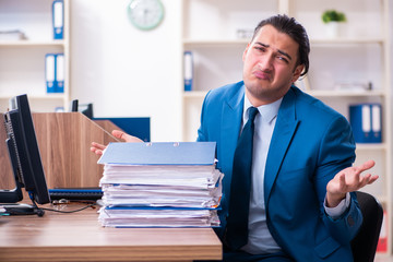 Young handsome businessman sitting in the office