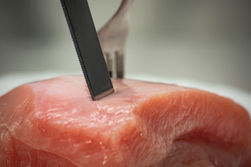 Knife in raw meat