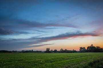 Beautiful clouds and a green field
