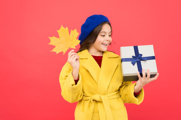 So beautiful. autumn kid fashion. happy small girl with maple leaf and present box. fall season. school shopping sales. girl child in french beret hold gift. Autumn weather change. thanksgiving day
