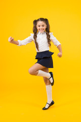 Fototapeta na wymiar Keep going. Active kid. Girl on way knowledge. Knowledge day. Back to school. Kid cheerful schoolgirl running. Pupil want study. Active child in motion. Freedom concept. Knowledge determined success