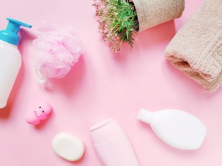  Flat lay photo baby care cosmetic products. Natural organic bath products. Liquid soap, shampoo, shower gel, sponge and rubber toy hippo