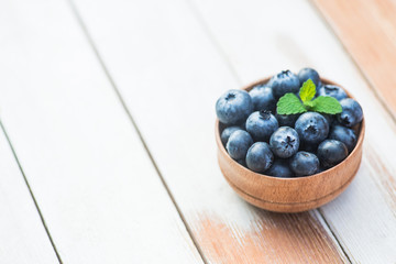 Fresh and natural blueberry with mint on a wooden table