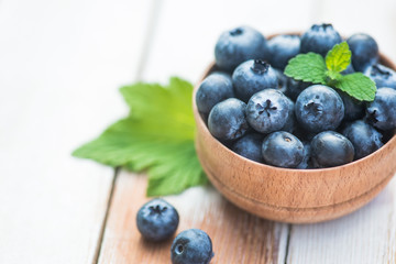 Fresh and natural blueberry with mint on a wooden table