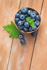 Fresh and natural blueberry with mint on a wooden table