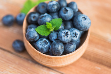 Fresh and natural blueberry with mint on a wooden table