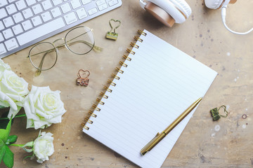 Office desk with computer and rose flowers