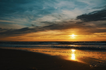 Beautiful sunset sky with partial clouds over North Sea ocean on island Texel in the Netherlands