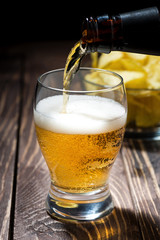 pouring beer from bottles and chips