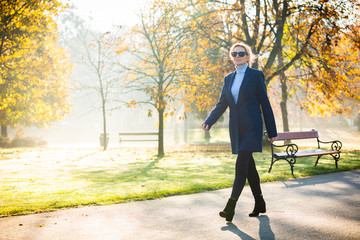 Middle-aged woman walking in city park