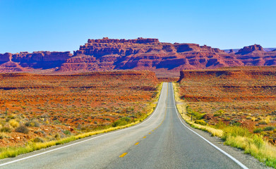 View of Monument Valley on a sunny day on the Highway 163 in Navajo Nation Reservation in USA.