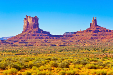 View of Monument Valley on a sunny day on the Highway 163 in Navajo Nation Reservation in USA.