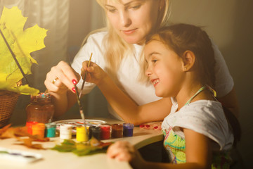 mother and daughter color autumn leaves