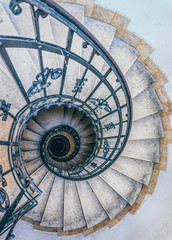Antique stone spiral staircase in the tower of the bell tower of the Catholic Church