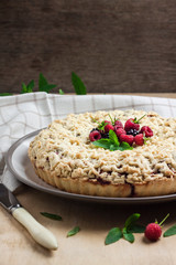 Berry shortcrust pie with crumble on a plate