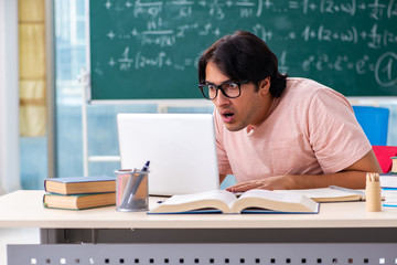 Young male student in the classroom