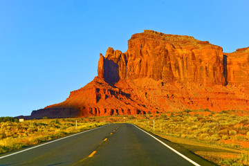 View of Monument Valley at sunset on the Highway 163 in Navajo Nation Reservation in USA.